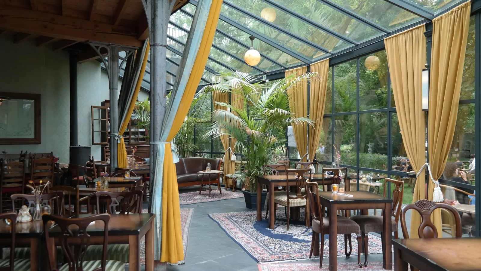 Glazen terrasoverkapping met gelaagd veiligheidsglas boven een tuinterras
